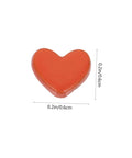 Product image of an orange heart-shaped rivet, measuring 0.2 inches, part of the 100 Pieces Heart Shaped Mini Doll Rivets For DIY Doll Clothes Fasteners