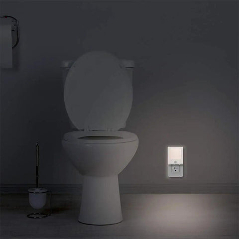 3 Pack No Fuss Motion Sensor Dimmable LED Night Lights Plug In Night Light with auto sensor illuminating a bathroom