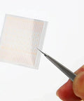 Close-up of 208 copper solder dots from the 208 Copper Solder Dots And Lugs Repair Kit For PCB And Mobile Phone Motherboard Repairs Precision Spot Soldering Pads For Jumper Wires And Board Pad Welding Pro Grade Soldering Essentials being held with tweezers.