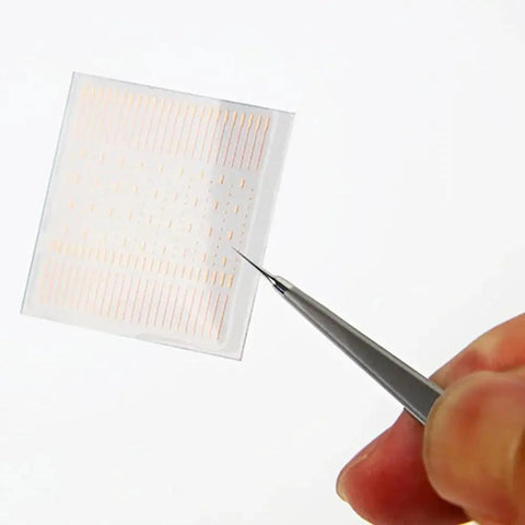 Close-up of 208 copper solder dots from the 208 Copper Solder Dots And Lugs Repair Kit For PCB And Mobile Phone Motherboard Repairs Precision Spot Soldering Pads For Jumper Wires And Board Pad Welding Pro Grade Soldering Essentials being held with tweezers.