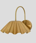 SHAHLUMES Handcrafted Curved Brass Flower Wall Sconce | Modern Bedside Wall Light | Side view of brass wall lamp with ruffled shade.
