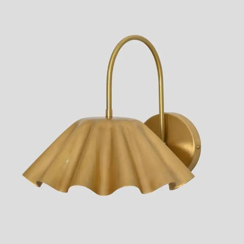 SHAHLUMES Handcrafted Curved Brass Flower Wall Sconce | Modern Bedside Wall Light | Side view of brass wall lamp with ruffled shade.