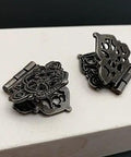 Close-up of Vintage Alloy Hollow Flower Hinges for Furniture and Cabinets 28x53mm, showing intricate design on wooden surface.