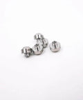 Close-up of 5 ruby orifice nozzles for water jet cutting pump; metallic silver
