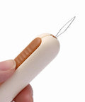 Close-up of hand holding 3 Pack 2 In 1 Needle Threader And Seam Ripper Set For Sewing Threading And Seam Removal Must Have Handy Tool