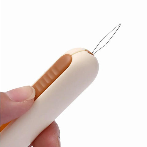 Close-up of hand holding 3 Pack 2 In 1 Needle Threader And Seam Ripper Set For Sewing Threading And Seam Removal Must Have Handy Tool