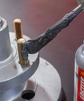 Loctite Automotive Silver Anti-Seize lubricant bottle applying to bolt threads on a wheel hub assembly.