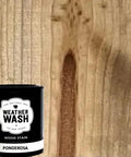Ponderosa Premium Interior Wood Aging Stain 5 Gallon Container on wood surface displaying a natural grain pattern.