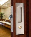 Privacy Pocket Door Lock Hardware With Key For Invisible Barn Doors In Brushed Nickel Finish installed on a wooden door.