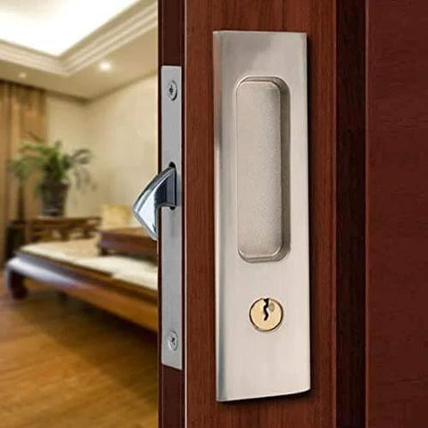 Privacy Pocket Door Lock Hardware With Key For Invisible Barn Doors In Brushed Nickel Finish installed on a wooden door.