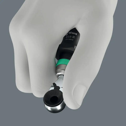 Hand holding Zyklop Mini 4 Bit Ratchet One Quarter Inch Drive Fifty Millimeter Hex Bit Holder with thumbwheel for fastening.
