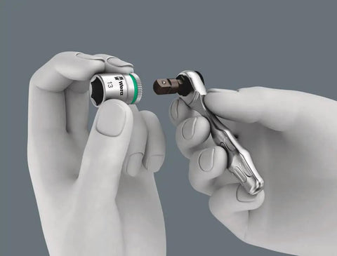 Hands using Compact 39 Piece Tool Set With Zyklop Mini One Quarter Inch Bit Mounting, bit being inserted into screwdriver.