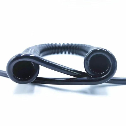 Heavy Duty Coiled Extension Cord That Snaps Back Quick Stretches Twelve Feet For Truck Beds And Workshops Delivers Reliable Three Core Power end view of flexible black coiled cord.