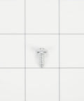 Close-up of a screw from Stainless Steel Slide-In Range Rear Filler Kit For Kitchen Appliances And Home Installations.