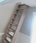 Kickass Water Based Wood Stain With A Slick Gray Brown Tint on a wooden staircase showing smooth weathered style.