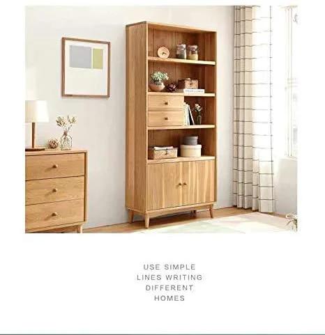 Wooden shelving unit with drawers and decor beside a light-filled window in a minimalist room.