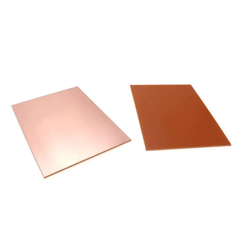 Two single-sided boards from Five Pack FR4 Copper Clad Laminate PCB Kit, 7x10cm, 1.4mm thick, laying flat.