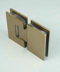 Rock Solid Frameless Glass Shower Door Hinge For Modern Bathrooms Featuring Zero Hassle Installation And Smooth 180 Degree Swing Action With Durable 304 Stainless Steel In Sleek Brushed Gold Finish. Close-up view of a brushed gold hinge.