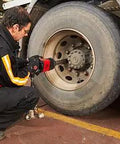 Man using Heavy Duty 1 Inch Drive Pneumatic Impact Wrench With 6 Inch Extended Square Anvil And Rust Proof Powder Coat Finish on truck tire.