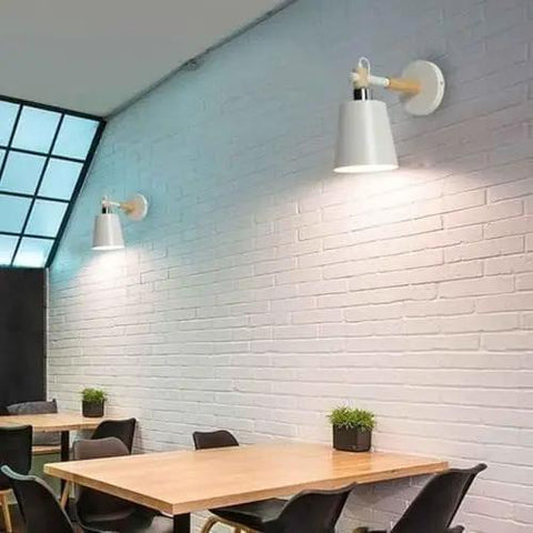 EDFGVH Single Heads Iron Art Lamp Body Wall Lamps with E26/E27 Metal Base Sconces 10.6in installed on a brick wall in a dining area.