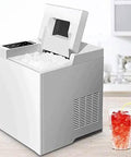 Reliable High Output Countertop Ice Maker Creates Fresh Nugget Ice Automatically With Self Cleaning Mode And Dual Cube Sizes For Effortless Cold Sips And No Sweat Family Gatherings on a kitchen countertop with a refreshing drink.