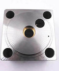 Waterjet end bell assembly front view; metal block with brass center bore and four mounting holes.