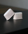 Activated charcoal water filter tablets for Delonghi espresso machines, two white cubes, with WANGENBRO logo.