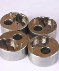 Top view of four 7/8-inch metal poppet housing components for waterjet pump accessories.