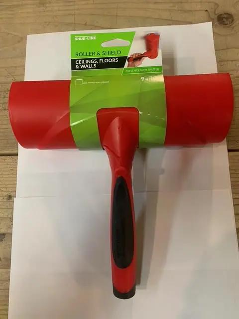 Nine Inch Paint Roller With Integrated Anti Splatter Shield And Heavy Duty Rubber Grip For No Sweat Wall Painting Plus Threaded Socket Attaches To Standard Poles Slick Smooth Coat Reusable Nap Cover Pack Of Ten, red roller with handle.