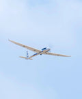 2000mm SZD-54 6 Channel RC Plane PNP Kit with Propeller flying in sky, white finish, no battery, charger, radio included.