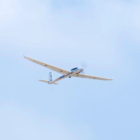 2000mm SZD-54 6 Channel RC Plane PNP Kit with Propeller flying in sky, white finish, no battery, charger, radio included.