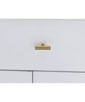 Single brass finish zinc alloy T bar drawer pull on white cabinet, part of 10 pack for cabinets and doors rust resistant with smooth edges.