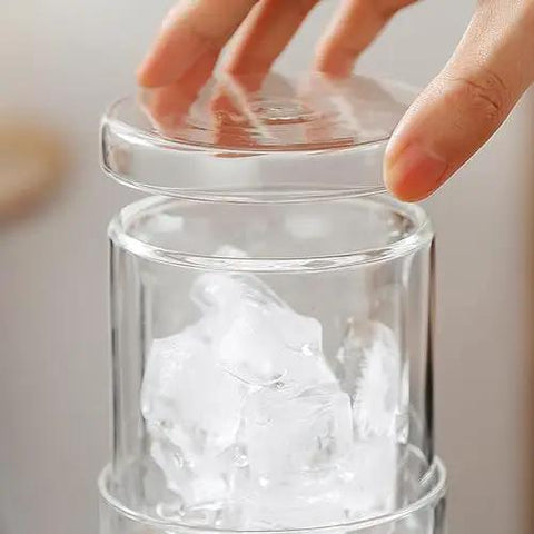 Close-up of Portable Cold Brew Coffee Maker With Slow Drip Tower and Adjustable Flow Control showing ice cubes in borosilicate glass.