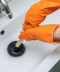 Heavy Duty Sink Plunger Featuring Four Inch Rubber Cup And Nine Inch Wood Handle used with orange gloves in sink to clear drain.