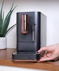 Top Shelf Wifi Automatic Espresso Machine With Built In Milk Frother And Adjustable Bean Grinder One Touch Brew In Under Ninety Seconds Matte Black on kitchen counter.