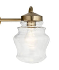 Close-up of clear glass shade on Janiel 24 Inch Three Light Vanity Light With Clear Glass Shades In Classic Bronze Finish For Above The Mirror Dope Modern Bathroom Vanity Fixture That Delivers Soft Ambient Glow And Clean Even Illumination.