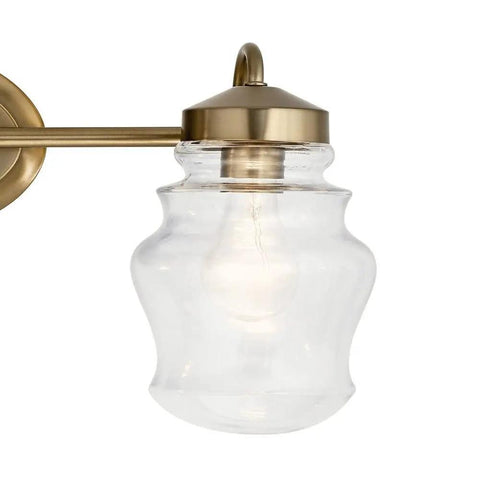 Close-up of clear glass shade on Janiel 24 Inch Three Light Vanity Light With Clear Glass Shades In Classic Bronze Finish For Above The Mirror Dope Modern Bathroom Vanity Fixture That Delivers Soft Ambient Glow And Clean Even Illumination.