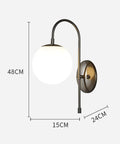Upgrade Your Vibe With Sleek Brass Wall Sconces Featuring Handcrafted White Glass Globe Shades ideal for modern farmhouse and bedroom lighting.