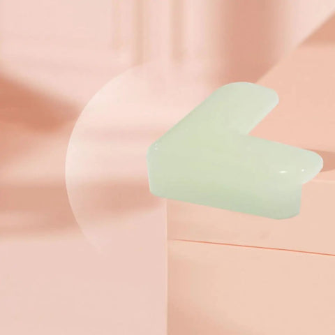 Light green PVC Night Light Corner Guard on furniture edge, L shaped protector for baby proofing dining tables and study desks.