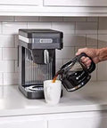 Person pouring coffee from Speed Brew Elite 10 Cup Coffee Maker With Internal Stainless Steel 70 Oz Hot Water Tank Quick Brew Technology