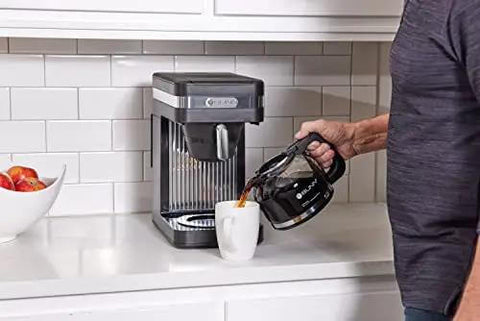 Person pouring coffee from Speed Brew Elite 10 Cup Coffee Maker With Internal Stainless Steel 70 Oz Hot Water Tank Quick Brew Technology