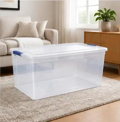 Heavy Duty 105 Quart Storage Bin With Secure Snap Latches And Clear Base in a living room setting with soft natural light.