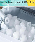 Portable Nugget Ice Maker, Plug And Play Electric Countertop Ice Machine With Free Scoop And Basket, Fast Chill Six Minute Batch showing ice cubes in large transparent window.
