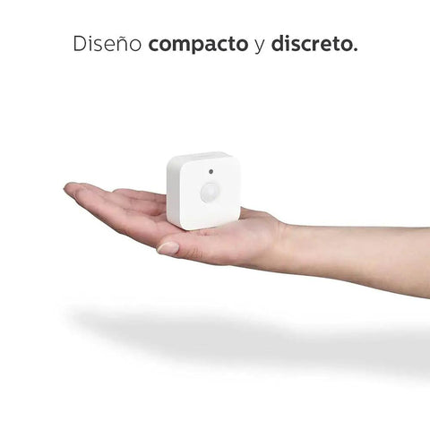 Compact white motion sensor from Motion Sensor Bundle With Two White A19 LED Bulbs For Smart Home Lighting Hands Free Activation in hand.