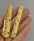 Close-up of Two Pack Golden Metal Hinges for Cabinets and Furniture Hardware held in hand, showcasing antique vintage look and design.