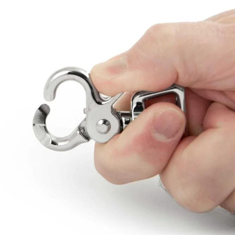 Close-up of nickel-plated die-cast trigger snap clip held in hand