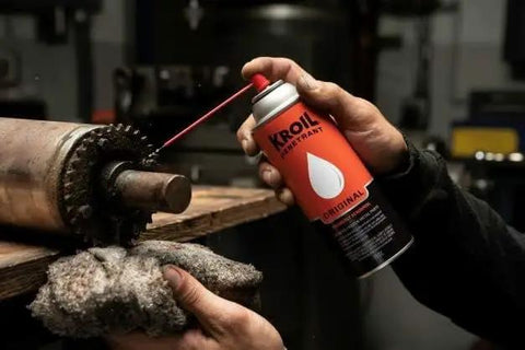 Person spraying Aerokroil Penetrant Rust Penetrating Lubricant And Corrosion Inhibitor Oil For Chains Hinges And Stuck Metal Parts onto gears