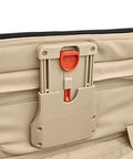 Briggs & Riley Baseline luggage latch on beige softside bag with orange release button (close-up)