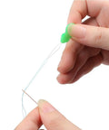 Close-up of hand using Colorful Needle Threaders Set Of 20 For Hand And Machine Sewing Tools For Crafting Knitting Quilting And DIY Art Ideal