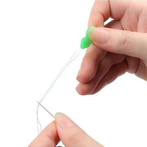 Close-up of hand using Colorful Needle Threaders Set Of 20 For Hand And Machine Sewing Tools For Crafting Knitting Quilting And DIY Art Ideal